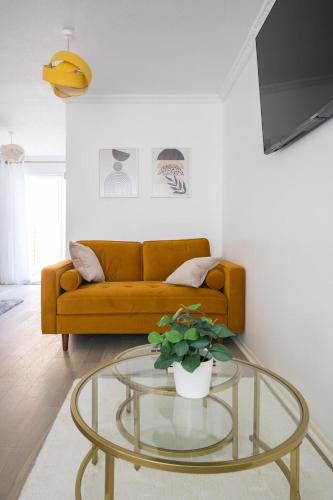 a living room with a couch and a glass table at Mallard house in Kent