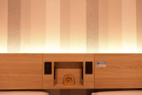 a wooden box with a toilet in a room at Kumamoto Washington Hotel Plaza in Kumamoto