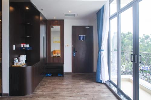 a hallway with a bathroom with a large window at SANDALS AQUILA HOTEL in Bao Loc