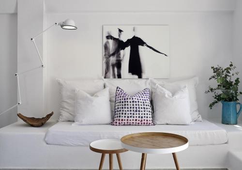 a living room with a couch with pillows and a table at Bellonias Villas in Kamari