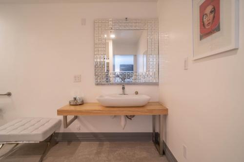 a bathroom with a sink and a mirror at Aqua Soleil Hotel and Mineral Water Spa in Desert Hot Springs