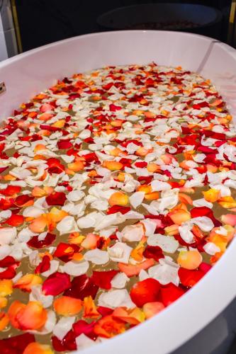 a white bowl filled with flowers on a table at SANDALS AQUILA HOTEL in Bao Loc
