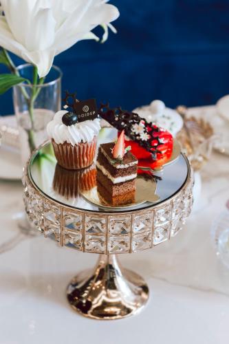 a plate with cakes and cupcakes on a table at SANDALS AQUILA HOTEL in Bao Loc