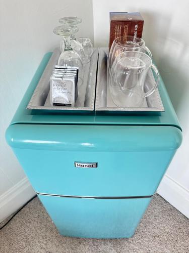 a blue cooler with glass jars and other items on it at The Second Story in Raton