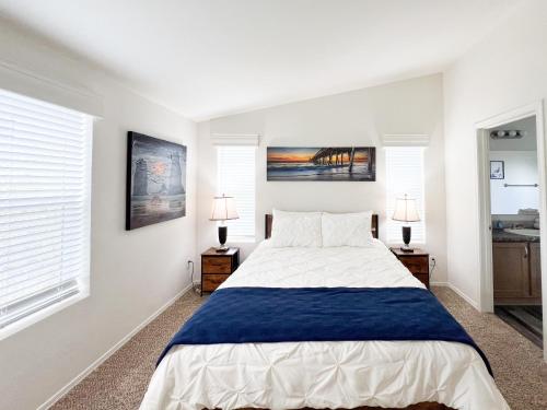 a bedroom with a large bed and two lamps at Ridgeview Oasis in Poway