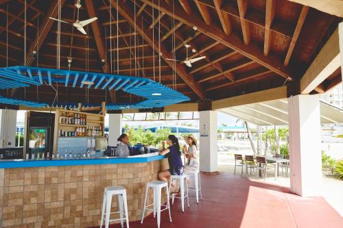 a group of people standing at a bar at Hoshino Resorts RISONARE Guam in Tamuning