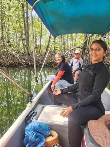 a group of people sitting on a boat in the water at Hospedaje Valencia Osa, CR in Potrero
