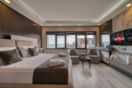 a bedroom with a large bed with chairs and a tv at Swans Hotel Old City Grand Bazaar in Istanbul