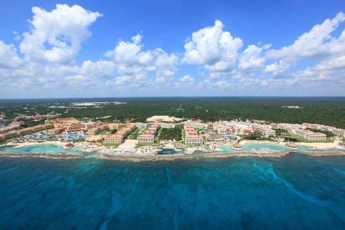 an aerial view of a resort in the ocean at Hard Rock Hotel Riviera Maya - All Inclusive in Puerto Aventuras