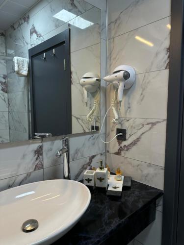 W łazience znajduje się umywalka i lustro. w obiekcie AGİOS HOTEL w mieście Gokceada