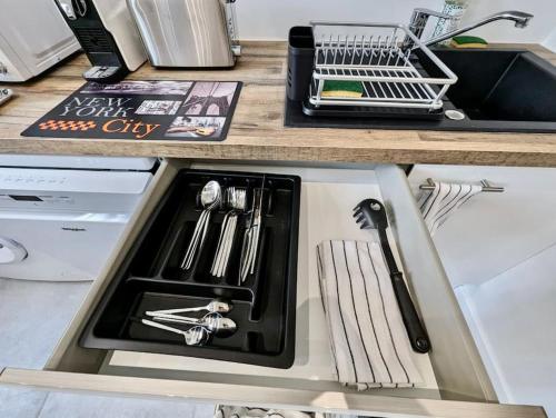 a kitchen counter with a sink in a kitchen at Excellent T2 - Moderne & Tout Equipé avec Parking in Grenoble