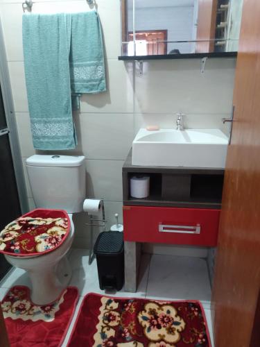 a small bathroom with a toilet and a sink at Casa barra velha sc in Barra Velha