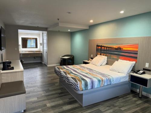 a bedroom with a large bed and a desk at Wave Hotel Manhattan Beach in Manhattan Beach