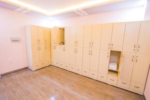 a row of lockers in a room with wood floors at Hotel Ngọc Ánh in Ho Chi Minh City