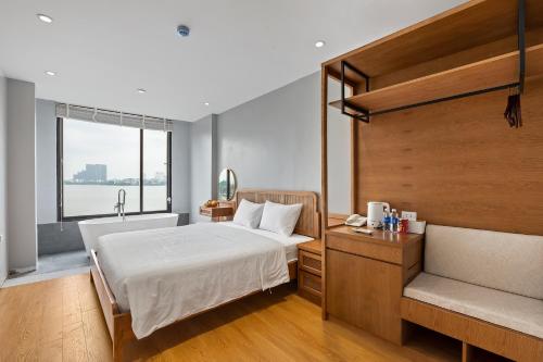 a bedroom with a bed and a sink and a window at Lakeview Residence Hotel in Hanoi