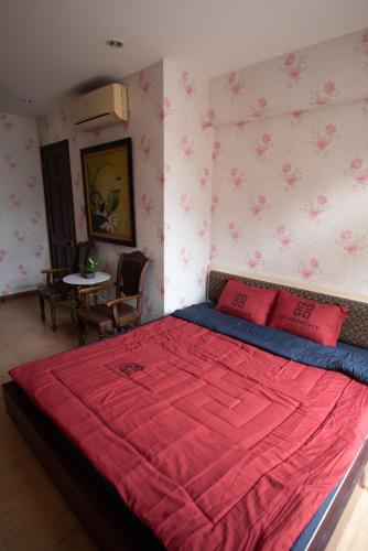 a bedroom with a large bed with red pillows at Small Room Close to TSN Airport Everspring house in Ho Chi Minh City