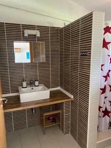 a bathroom with a sink and a mirror and a shower at Apartments Lili in Baška