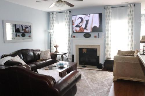 a living room with a couch and a fireplace at Safari Rooms in Concord