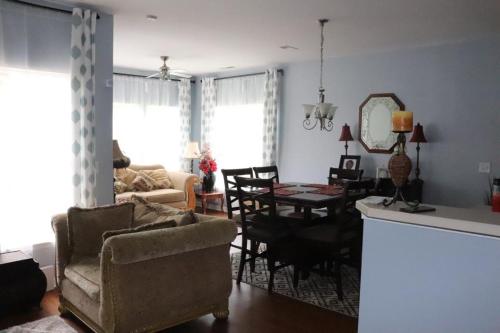 a living room with a couch and a dining room at Safari Rooms in Concord