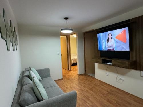 a living room with a couch and a flat screen tv at Dep completo a 5min del foro sol, y del aeropuerto in Mexico City