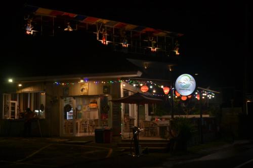 a restaurant at night with a sign in front of it at Bhuana Agung Villa and Restaurant in Jatiluwih