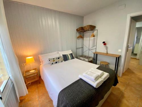 a bedroom with a large white bed and a shelf at Casa Horta View By MyRentalHost in Barcelona