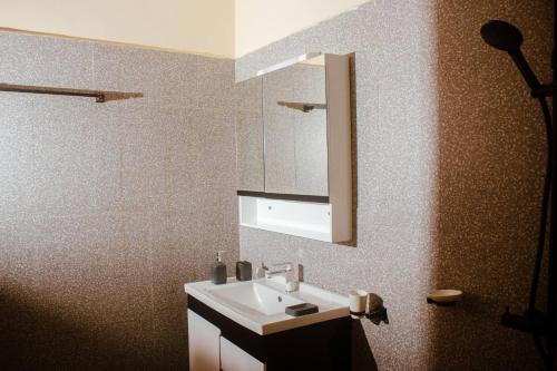 a bathroom with a sink and a mirror at Kadoued Furnished Apartment 2 Bedroom in Ouagadougou