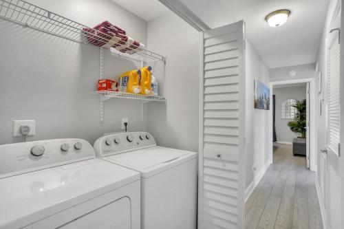 a white laundry room with a washer and dryer at Seaside Oasis 52 in Fort Myers