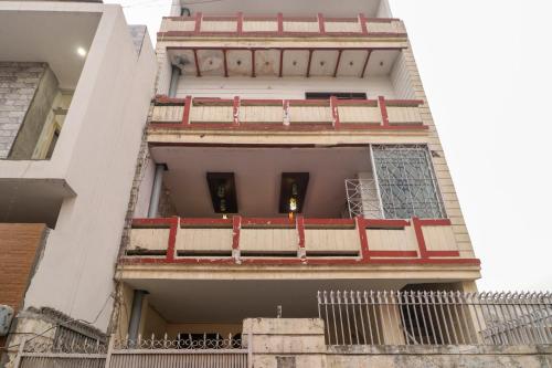 a building with red balconies on the side of it at Hotel O Sky Garden in Ludhiana
