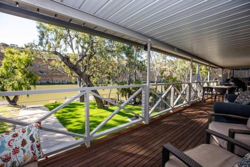 a screened porch with a view of a tree at 103 at Walkers in Walker Flat