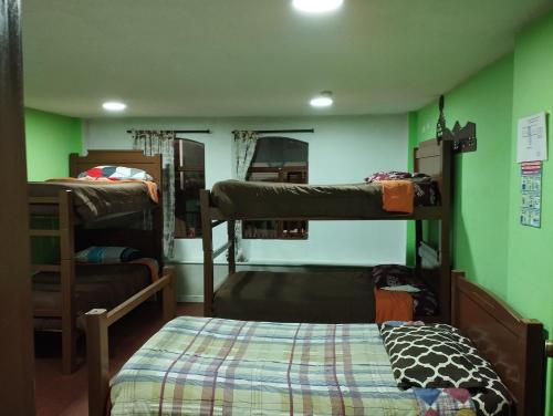 a room with three bunk beds and a bed at Hotel Tradiciones Quito Foch in Quito