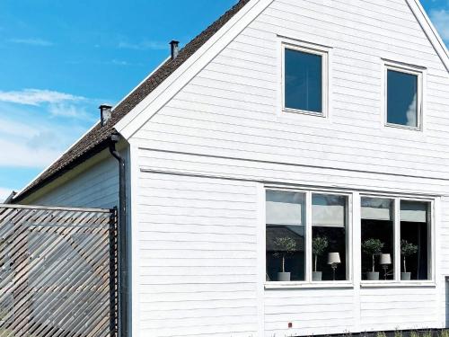 a white house with windows on the side of it at 4 star holiday home in KÖPINGSVIK-By Traum in Köpingsvik