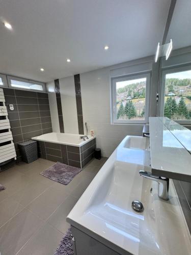a large bathroom with a tub and a sink at Villa Alia in Gérardmer