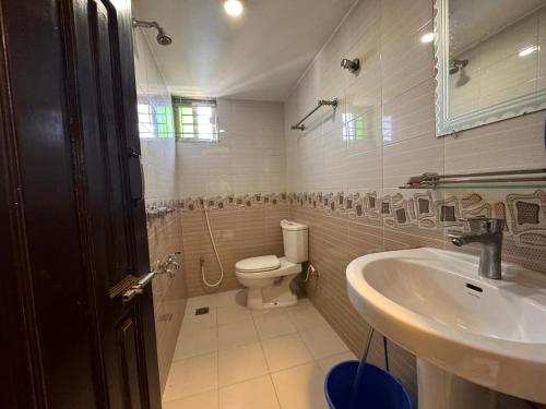 a bathroom with a toilet and a sink at stunning apartment in Sylhet