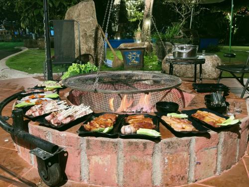 a barbecue grill with several different types of food at Mộc Hoa Viên in Ấp Thiện Lập