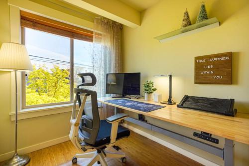 an office with a desk with a computer and a window at Stylish North Seattle Townhouse- Dual Master Suites in Seattle