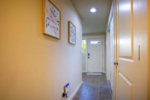 a hallway with a door and a tile floor at Stylish North Seattle Townhouse- Dual Master Suites in Seattle