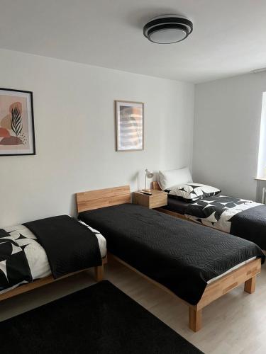 a bedroom with two beds and a room with at FMA Ferienwohnung Heubach in Heubach