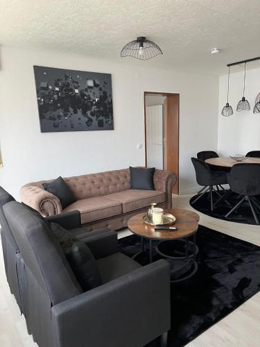 a living room with a couch and a table at FMA Ferienwohnung Heubach in Heubach
