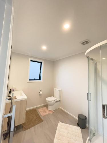 a bathroom with a toilet and a sink and a shower at Quiet and private room for stay in Wellington