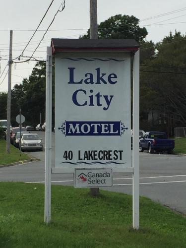 a sign for a lake city motel on the side of a road at Lake City Motel in Halifax