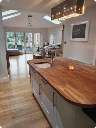 a kitchen with a large island with a wooden counter top at Spacious 3-Bed Home in York Free Parking Sleeps 5 in York