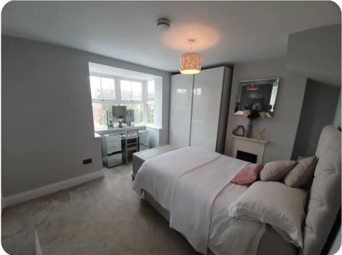 a bedroom with a bed and a sink and a window at Spacious 3-Bed Home in York Free Parking Sleeps 5 in York