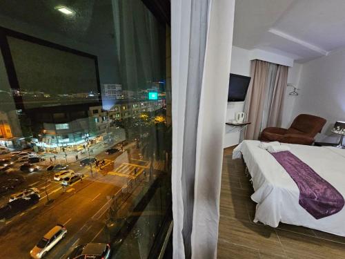a hotel room with a view of a city at Warisan Hotel Kota Kinabalu in Kota Kinabalu