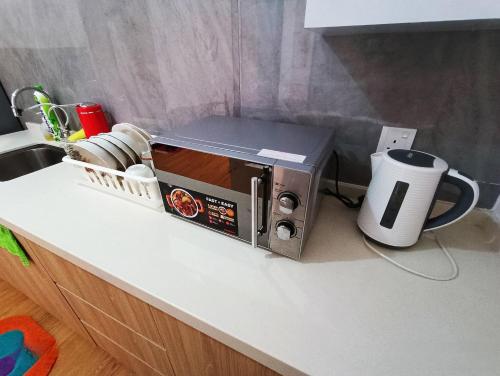 a toaster oven sitting on a kitchen counter at Imperio Residence Melaka by Jeffery Lam Home Management in Melaka