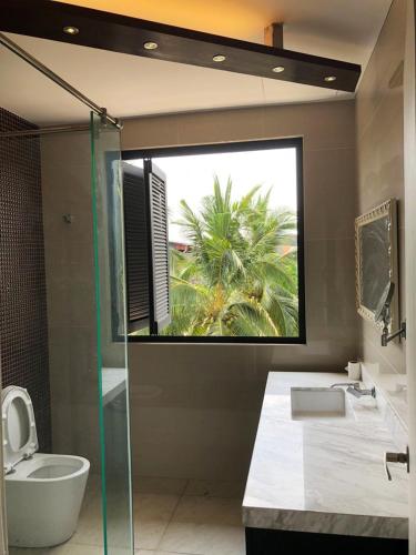 a bathroom with a shower and a toilet and a sink at Flamingo Homestay Port Dickson in Port Dickson