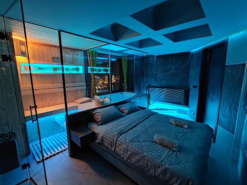 a bedroom with a bed and a bath tub at Private Spa Penthouse in Skopje