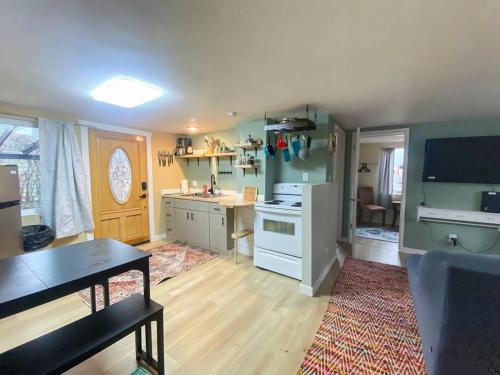 a kitchen with a table and a dining room at 2 bed 1 bath cottage home in Price