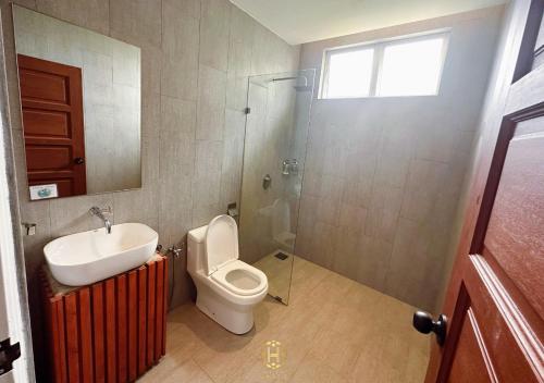 a bathroom with a toilet and a sink and a shower at The Luxurious 245, A Famosa Melaka in Kampong Alor Gajah