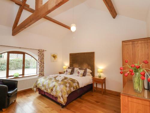 Schlafzimmer mit einem Bett und einem Fenster in der Unterkunft Dairy Cottage in Staintondale